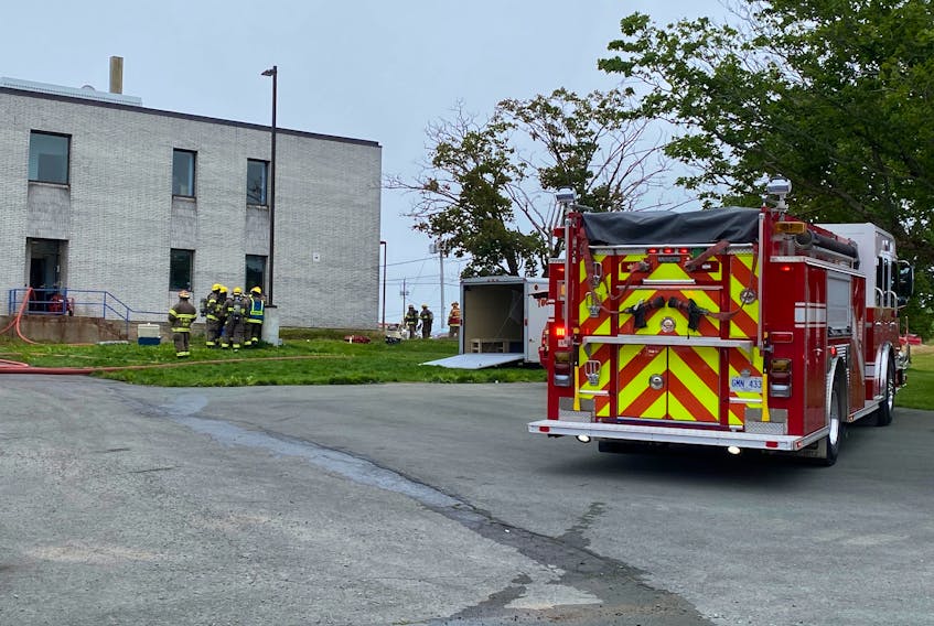 Firefighters enter the first floor of a Newfoundland and Labrador agricultural building on Brookfield Road in St. John's on Wednesday morning, Aug. 17, 2022.