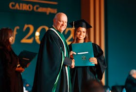 UPEI interim president Greg Keefe, left, presents UPEI Cairo Campus graduate Malak ElShaer with her bachelor of business administration degree. Contributed