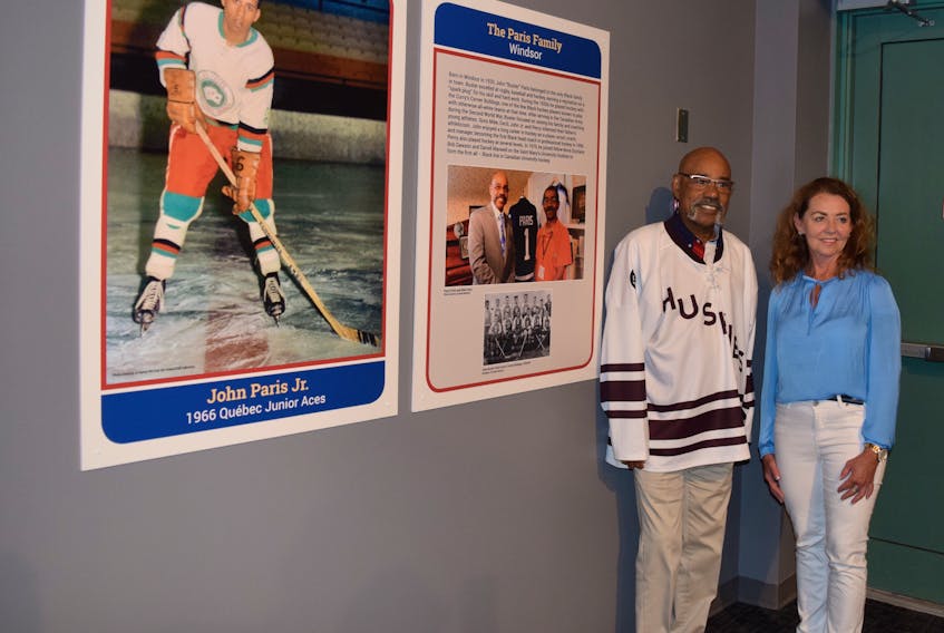 Percy Paris recently toured the hockey exhibit at the Museum of Industry along with Denise Taylor, marketing services operator at the MOI.