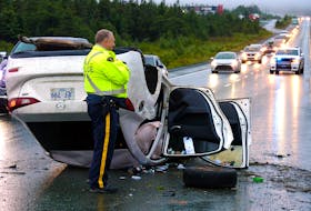 An overturned car sits on the highway following a single-vehicle crash on the Trans-Canada Highway near St. John's Thursday evening. Saltwire Network