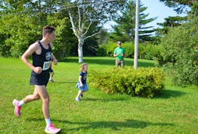 Will Bryden of Charlottetown approaches the finish line in the 2021 Malpeque Bay Credit Union Harvest Festival 25K Road Race's finish line in Kensington. Bryden was the race’s overall winner with a time of one hour 38 minutes 50 seconds (1:38:50). Jason Simmonds • The Guardian