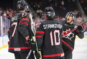 Canada's Will Cuylle (27), Logan Stankoven (10) and Donovan Sebrango (7) celebrate a goal against Switzerland during second period IIHF World Junior Hockey Championship quarterfinal action in Edmonton on Wednesday August 17, 2022.