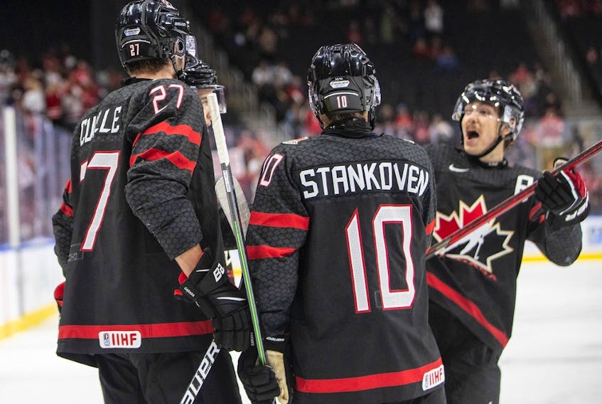 Canada's Will Cuylle (27), Logan Stankoven (10) and Donovan Sebrango (7) celebrate a goal against Switzerland during second period IIHF World Junior Hockey Championship quarterfinal action in Edmonton on Wednesday August 17, 2022.