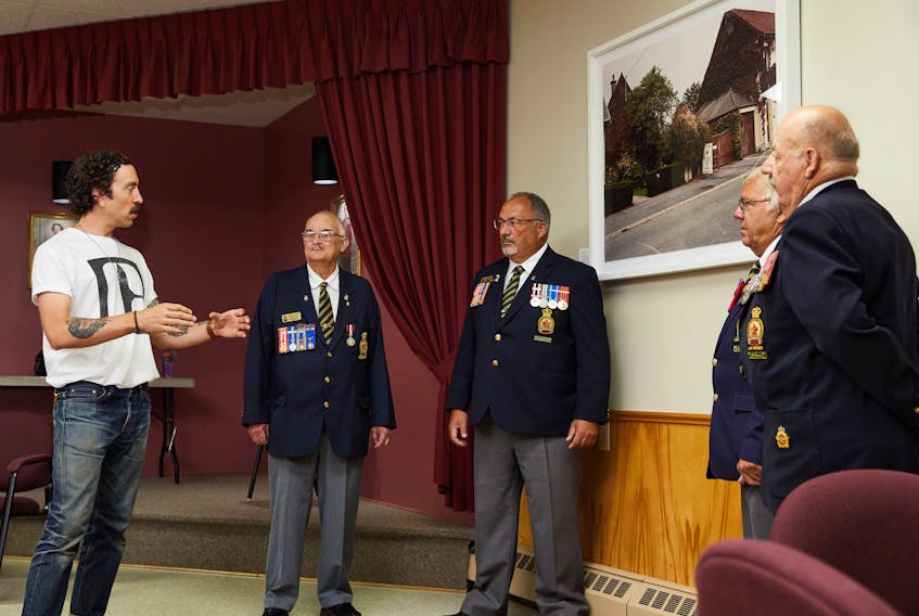 Professional photographer Rémi Thériault, left, was pleased to explain the intent of his photo, Neuville St-Vaast, as he presented it as a gift to Wellington Royal Canadian Legion executive member Albert Hashie, service officer and executive member Mario Couture, president David Gallant and past president Gilles Painchaud.