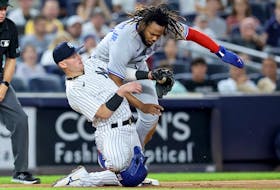 Blue Jays' Vladimir Guerrero Jr. slides safely into third on a single by Lourdes Gurriel Jr. (not pictured) ahead of the tag by Yankees' Josh Donaldson during the fifth inning at Yankee Stadium in New York on Thursday, Aug. 18, 2022. 