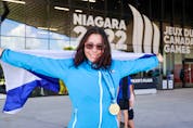 Joy MacLachlan of Halifax smiles while proudly showing off her gold medal for the Special Olympics women's 100 metre. - Len Wagg/Communications Nova Scotia