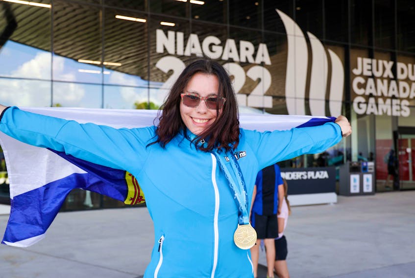 Joy MacLachlan of Halifax smiles while proudly showing off her gold medal for the Special Olympics women's 100 metre. - Len Wagg/Communications Nova Scotia