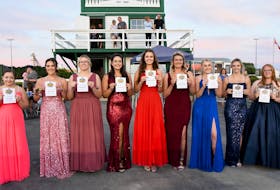 The Gold Cup and Saucer Ambassadors hold up a sheet of paper identifying the horses they are representing in the 63rd running of the $100,000 race, presented by the Atlantic Lottery Corporation, at Red Shores Racetrack and Casino at the Charlottetown Driving Park on Aug. 20. From left: Karley Affleck, Bettim Again; Faith Gavin, Time To Dance; Hailey Morrell, Ideal Perception; Sophie Quinn, Patrikthepiranha A; Alexis Mundle, Laughagain Hanover; Ashley MacDonald, No Plan Intended; Maddy Clow, Major Hill; Haley Cameron, Rhodena Road, and Isabella MacKay, Sintra. Gail MacDonald Photo
