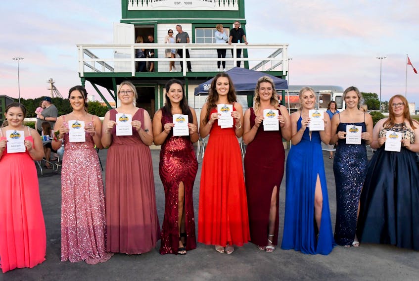 The Gold Cup and Saucer Ambassadors hold up a sheet of paper identifying the horses they are representing in the 63rd running of the $100,000 race, presented by the Atlantic Lottery Corporation, at Red Shores Racetrack and Casino at the Charlottetown Driving Park on Aug. 20. From left: Karley Affleck, Bettim Again; Faith Gavin, Time To Dance; Hailey Morrell, Ideal Perception; Sophie Quinn, Patrikthepiranha A; Alexis Mundle, Laughagain Hanover; Ashley MacDonald, No Plan Intended; Maddy Clow, Major Hill; Haley Cameron, Rhodena Road, and Isabella MacKay, Sintra. Gail MacDonald Photo