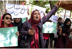 Members of Afghanistan’s women’s movement take part in a protest in Kabul on May 10, 2022, with some chanting "burqa is not my hijab,” after the Taliban ordered women to cover fully in public, including their faces. — Wakil Kohsar/Postmedia file photo