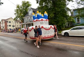A large inflatable birthday cake was part of the parade to mark the event's 60th year.