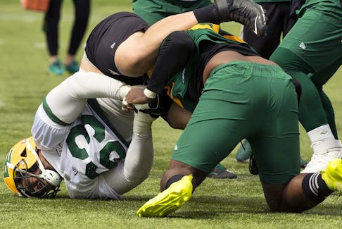 Jaylan Guthrie (63) and Ese Mrabure (92) get into a fight during an Edmonton Elks practice at Commonwealth Stadium in Edmonton on Tuesday, Aug. 2, 2022.
