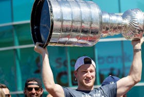 August 20, 2022--Colorado Avalanche forward Nathan MacKinnon holds the Stanley Cup aloft during his parade Saturday. 
ERIC WYNNE/Chronicle Herald