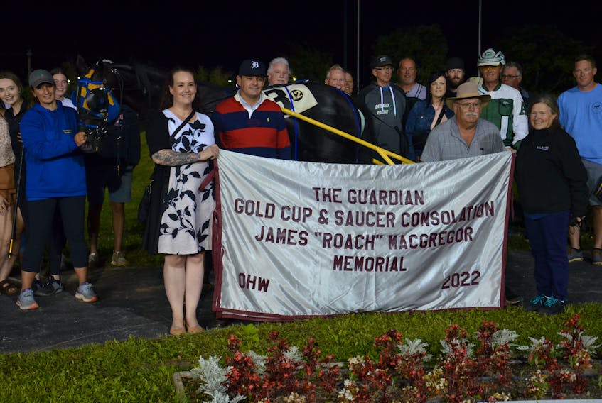 Twin B Tuffenuff won the James (Roach) MacGregor Memorial Gold Cup and Saucer Consolation Pace in an exciting finish at Red Shores Racetrack and Casino at the Charlottetown Driving Park on Aug. 19. Twin B Tuffenuff, driven by Kenny Arsenault for owner Pat Morris of Charlottetown, edged out Cadillac Bayama in 1:51.1. Abby Oliver, front left, and Charlene Lund, front right, representing The Guardian and SaltWire Network, presented the cooler to the winning connections. Jason Simmonds • The Guardian