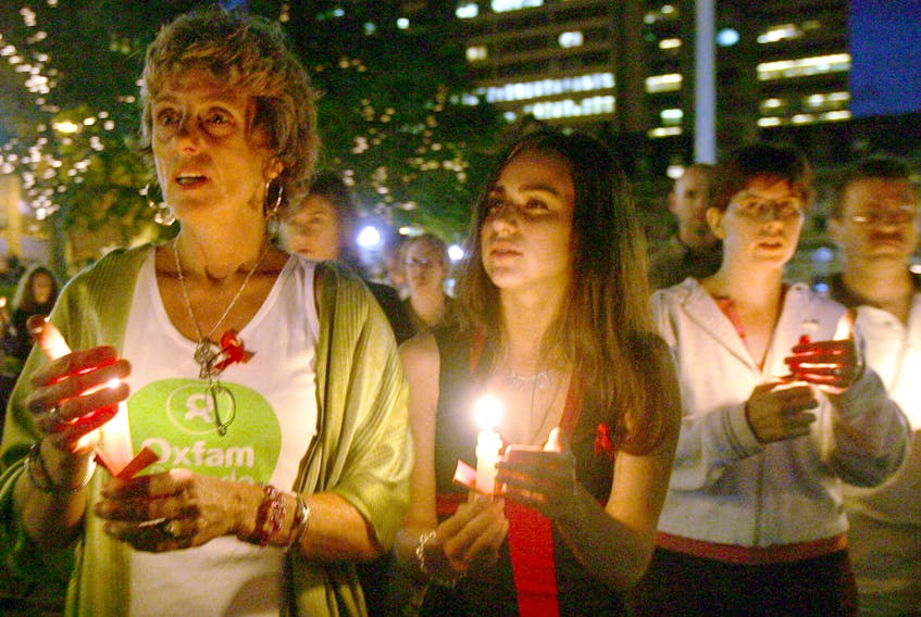 MAKE AIDS HISTORY RALLY AND VIGIL-AIDS activist and MC of this years Rally and Vigil to Make AIDS History, Janet Connors, left stands with Leah Hanakowski Thursday night at the Grand Parade during the beginning of a candlelight walk to Victoria Park in Halifax.
 TED PRITCHARD/ Staff