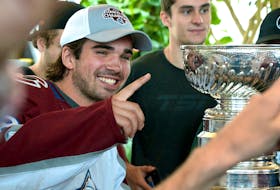 Colorado Avalanche player and Stanley Cup Champion Alex Newhook Poses for photos after Newhook brought the Stanley Cup down stairs at St. John’s International airport Sunday afternoon.

Keith Gosse/The Telegram