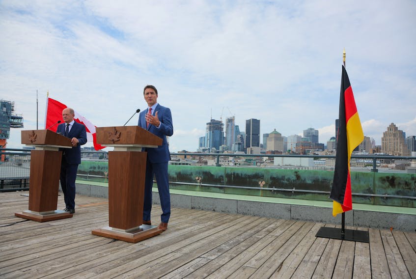 German Chancellor Olaf Scholz and Prime Minister Justin Trudeau speak to the media outside the Montreal Science Centre, in Montreal on Monday, August 22, 2022. - Christinne Muschi / Reuters