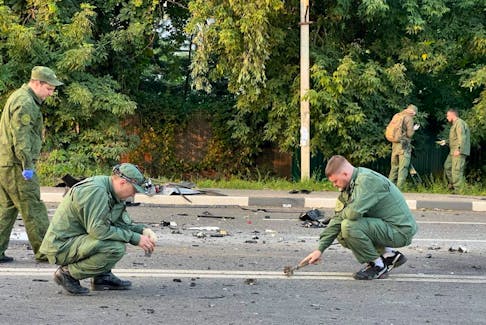 Investigators work at the site of a suspected car bomb attack that killed Darya Dugina, daughter of ultra-nationalist Russian ideologue Alexander Dugin, in the Moscow region, Russia August 21, 2022. Investigative Committee of Russia/Handout via REUTERS ATTENTION EDITORS - THIS IMAGE HAS BEEN SUPPLIED BY A THIRD PARTY. NO RESALES. NO ARCHIVES. MANDATORY CREDIT.  Investigators work at the site of a suspected car bomb attack that killed Darya Dugina, daughter of ultra-nationalist Russian ideologue Alexander Dugin, in the Moscow region of Russia Aug. 21, 2022. - Investigative Committee of Russia/Handout via REUTERS