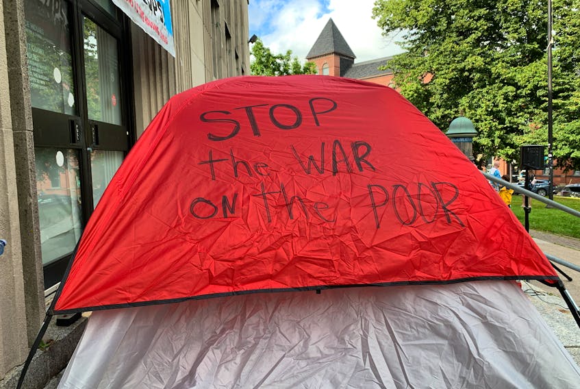 A tent bearing a message about the housing crisis was set up on the steps of the former public library on Spring Garden Road at a rally to mark one year since police evicted people from encampments at various sites in Halifax.