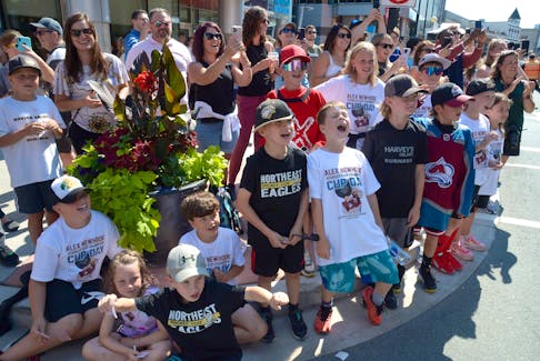A group of young and older fans shout to Stanley Cup champion Alex Newhook during the parade in his honour Monday afternoon.

Keith Gosse/The Telegram