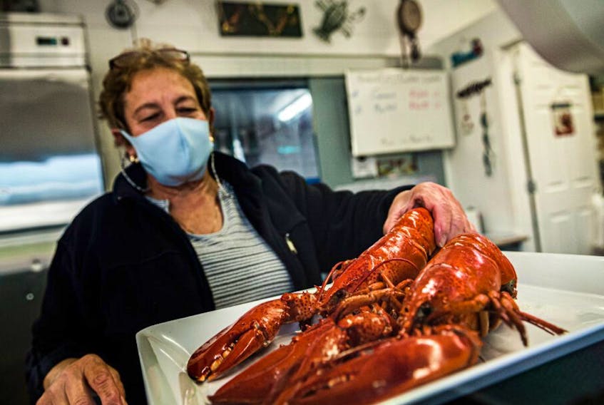 A employee weighs lobster in Shediac, N.B., on Wednesday, September, 22, 2021.