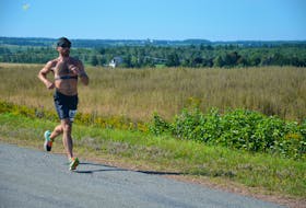 Bill MacDonald runs the final few kilometres of the 48th Harvest Festival Road Race in Kensington on Aug. 20. MacDonald, from Cornwall, P.E.I., was the overall winner of the 25-kilometre event in a time of one hour 36 minutes 58 seconds (1:36:58). Jason Simmonds • The Guardian