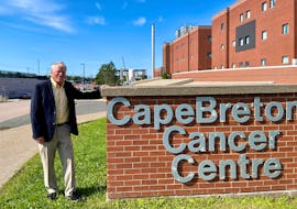 Dr. Rex Dunn stands next to the sign for the Cape Breton Cancer Centre. He and his wife recently donated to the Cancer Care Here at Home campaign.
PHOTO CREDIT: Contributed