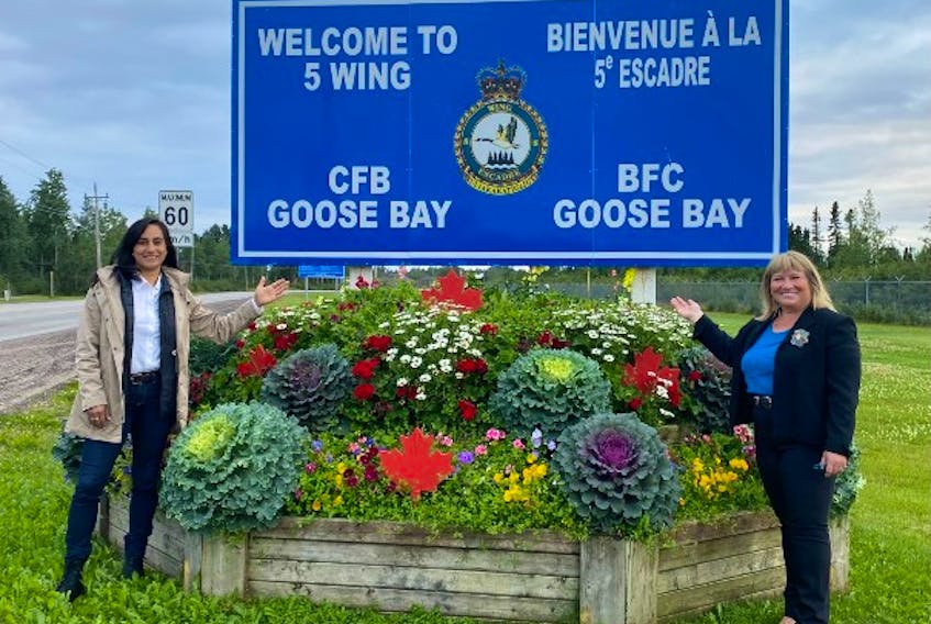 Defence Minister Anita Anand, left, and Labrador MP Yvonne Jones stand at the 5 Wing Goose Bay sign after Anand announced plans for infrastructure upgrades at the base. Contributed