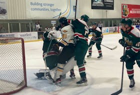 Halifax Mooseheads defenceman Jack Martin, right, tries to prevent Cape Breton Eagles forward Thomas Desruisseaux from banging into goalie Brady James during a QMJHL pre-season game at the RBC Centre in Dartmouth on Wednesday.