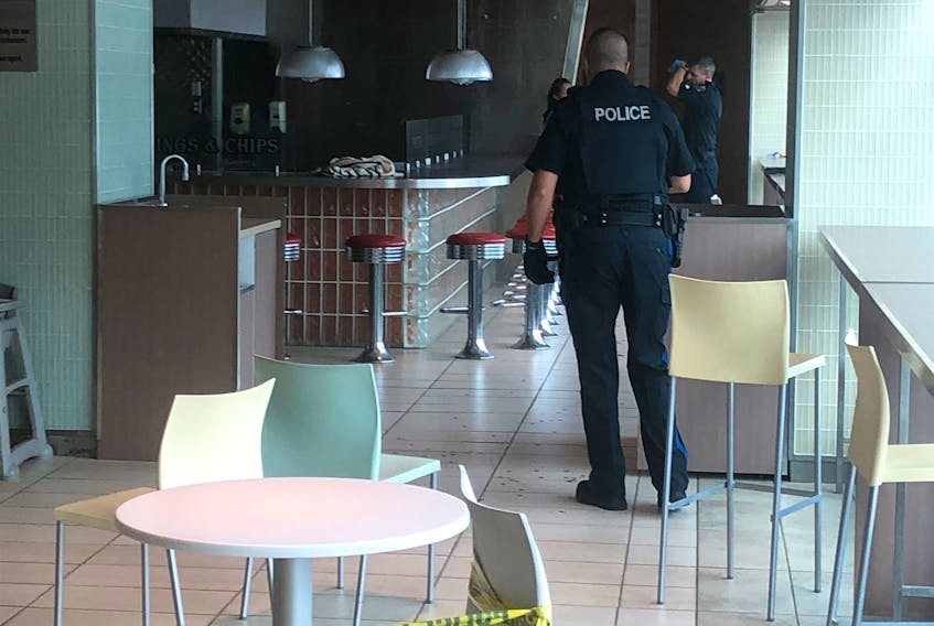 A Royal Newfoundland Constabulary officer was taken to hospital by Eastern Health paramedics after he was allegedly stabbed at the Atlantic Place food court in downtown St. John's on Wednesday afternoon, Aug. 24. The handcuffed female was seen being escorted from Atlantic Place. Inside, the RNC had most of the food court area cordoned off with yellow police tape as officers carried out their investigation, mainly in the washroom area where there was a large amount of blood visible on the floor. Joe Gibbons/The Telegram