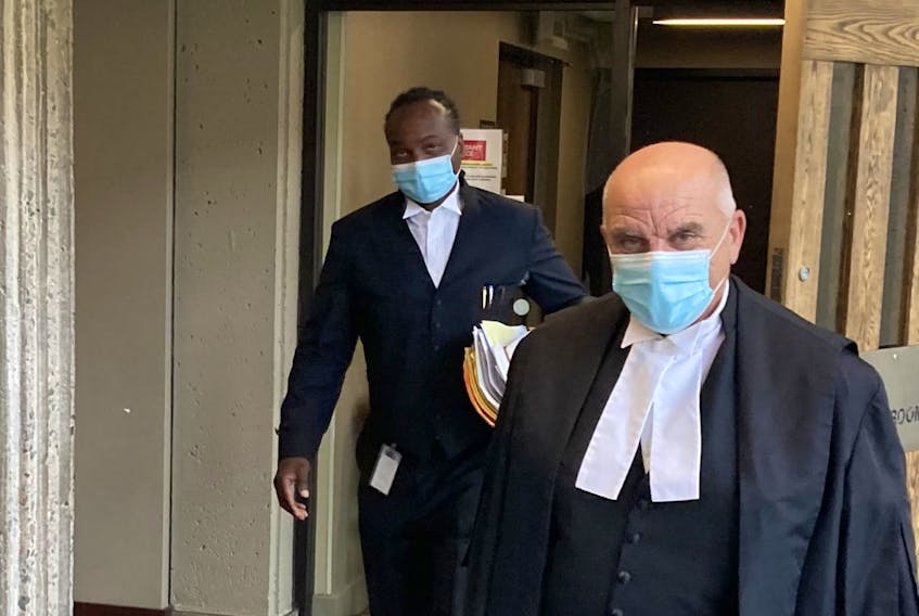Crown attorney Alonzo Wright, left, and defence lawyer Peter Mancini leave Nova Scotia Supreme Court in Halifax on Friday after James Michael Snow’s sentencing for exposing his genitals to a girl at the Truro Walmart store.