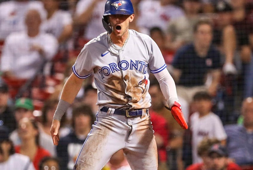 Toronto Blue Jays second baseman Cavan Biggio reacts after scoring during the tenth inning against the Boston Red Sox at Fenway Park in Boston on Aug. 25, 2022.