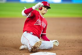 Shohei Ohtani of the Los Angeles Angels slides into third base with an RBI triple against the Toronto Blue Jays.