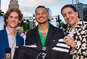Bay Roberts native and New Jersey Devils star Dawson Mercer (left) played a different role at the Prudential Centre in Newark, New Jersey over the weekend. The 20-year-old co-hosted the 2022 MTV Music Video Awards alongside Arthur Kade (right). Here, the pair display a Devils’ jersey with country music star Kane Brown. New Jersey Devils Facebook