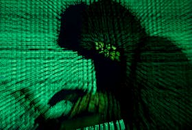 FILE PHOTO: A man holds a laptop computer as cyber code is projected on him in this illustration picture taken on May 13, 2017. REUTERS/Kacper Pempel  After a cyberattack plunged hospitals in Newfoundland and Labrador into a crisis last year, federal, provincial and territorial governments across Canada are ramping up cybersecurity for the health-care sector. -Reuters Inc. file photo