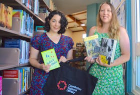 Emily Chasse, left, branch manager at the James McConnell Memorial Library in Sydney, and Lindsay Thompson, a library assistant in the children’s program, hold a few of the hundreds of books people can purchase during the Cape Breton Regional Library summer book sale. People can fill a bag with books for just $5 with all proceeds going to support children’s programs at the library. “Everything costs money — even buying coloured paper costs a lot of money — so any little bit that we can have to go toward our programs really helps because we try to keep up a regular Saturday program where people can come in and they have something to do here every Saturday with their kids, so it takes a lot of money to get supplies,” said Thompson. The Cape Breton Regional Library also accepts donations of gently used books for the book sale collection with the exception of thesauruses, dictionaries, textbooks and encyclopedias, or items that are in poor condition or damaged. Chris Connors/Cape Breton Post