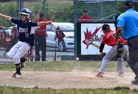 Parker Spencer of the Sydney Major Sooners, left, makes the safe sign after crossing the plate as Glace Bay McDonald’s Colonels pitcher Jordan O’Neill tries to catch the ball during the Nova Scotia Major Little League championship game at Cameron Bowl in Glace Bay on July 25. Spencer and the Sooners will compete in the Canadian Little League Championship in Calgary, Alta., beginning Friday. JEREMY FRASER/CAPE BRETON POST