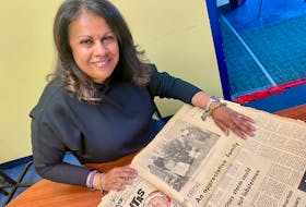 Nimira Parpia flips through old editions of the Yarmouth Vanguard newspaper from 1972 to read articles that were written about her refugee family at the time. She and seven other members of her family came to Yarmouth after being forced from their home in Uganda with nowhere else to go. TINA COMEAU PHOTO