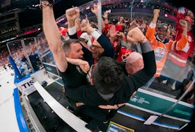 Athletic therapist Kevin Elliott, left, and head coach Dave Cameron, second left, celebrate with Team Canada staff members following a 3-2 overtime win over Finland in the gold-medal game of the 2022 International Ice Hockey Federation world junior hockey championship at Rogers Place in Edmonton on Aug. 20. Cameron, head coach of the Ontario Hockey League’s Ottawa 67’s, resides during the off-season in Kildare Capes, P.E.I. Elliott, manager of medical services for Hockey Canada, is a former athletic therapist with the Charlottetown Islanders and has a home in Charlottetown. Matt Murnaghan • Hockey Canada Images