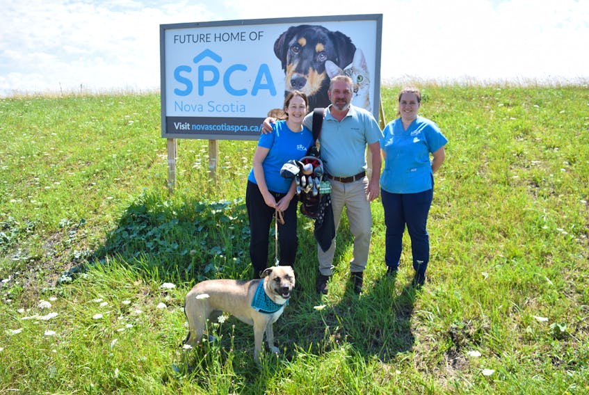 Katy Downing, left, and Danielle O'Brien joined Vince Angst at the site of the soon to be constructed SPCA building in Stellarton. Angst is organizing the Kathy Skoke-Fortin Memorial Golf Tournament which raises money for the organization. Also pictured is Angst's dog Mira, who he got from the SPCA in June 2021. ADAM MACINNIS