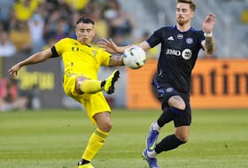 Columbus Crew's Lucas Zelarayan, left, clears the ball past CF Montréal's Joel Waterman during the first half of MLS action in Columbus Wednesday night.