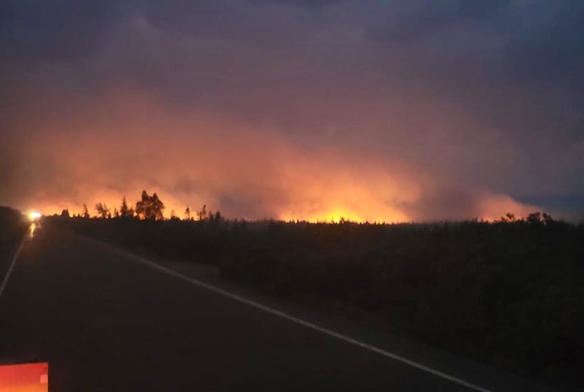 Smoke and flames seen at night from the forest fire on the Bay d’Espoir Highway. - Claudette Nichole Bennett Piercey, image from Facebook