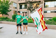 R.J. Hetherington, left, and Vanessa Keefe pose with a Prince Edward Island flag. Hetherington and Keefe, members of the Team P.E.I. wrestling team, have been selected as flag-bearers for the opening ceremonies of the 2022 Canada Summer Games in St. Catharines, Ont., on Aug. 6. Photo Courtesy of P.E.I. Canada Games