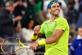 Rafael Nadal celebrates his victory against Novak Djokovic during the men's singles quarterfinal match at the French Open in Paris May 31, 2022.