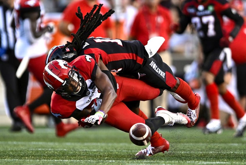  Calgary Stampeders wide receiver Kamar Jorden (88) grimaces as he is tackled by Ottawa Redblacks defensive back Abdul Kanneh (14) during first half CFL football action in Ottawa on Friday, Aug. 5, 2022.