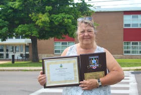 Pam Arsenault recently retired after spending 30 years as a crossing guard near Elm Street Elementary School. In early August, the city and Summerside Police Service surprised her with a plaque to commemorate her years of dedication. - Kristin Gardiner