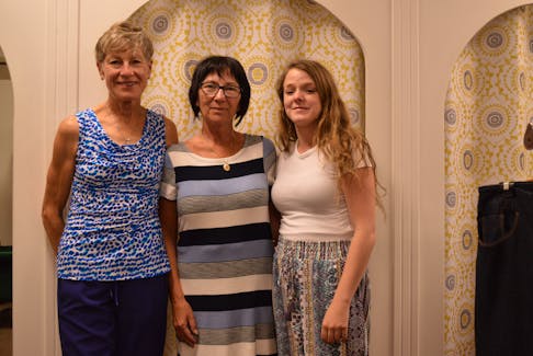 Shelley MacEwen, left, and Blaze Gallant, right, take a moment to pose with their boss, Mary Matthews, co-owner of Repeats Quality Used Family Clothing on Aug 2. - Alison Jenkins • The Guardian