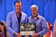 Brad Richards accepts a plaque honouring his inauguration into the P.E.I. Sports Hall of Fame from uncle Jamie Richards Aug. 8 in Murray River.