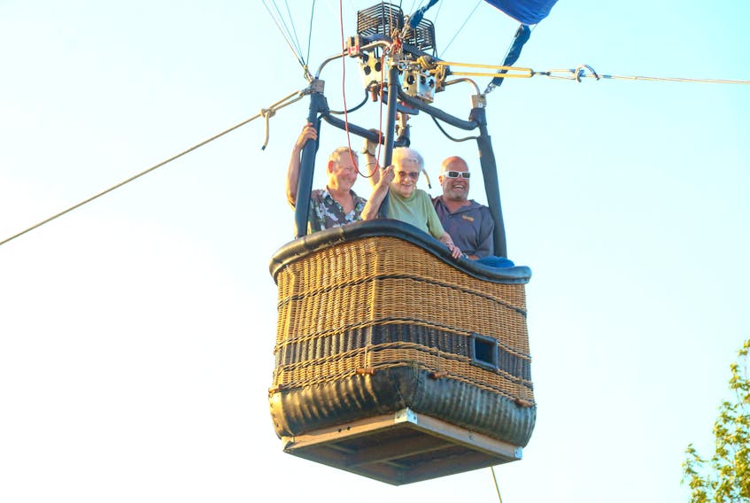 Gloria Veinott has checked another item off her bucket list. On July 31, the 91-year-old went up in a tethered hot air balloon. Pictured with her are her son-in-law Gordon Boyd, left, and pilot Scott MacRitchie.
