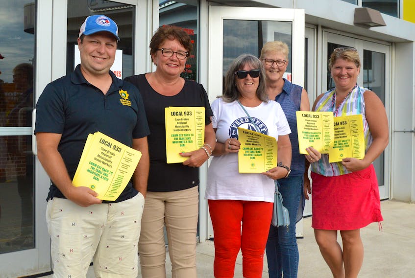 Cape Breton Regional Municipality inside workers were handing out flyers Monday evening outside Centre 200. The Canadian Union of Public Employees local 933 represents 140 people who work at Transit Cape Breton, 911 and 311 regional emergency communication centres, police services, the civic works centre, the engineering and public works department, the Sydney lockup, water utility, the solid waste management department, and facilities such as the Centre 200 and Cape Breton County Recreation Centre. The union recently voted in a favour of strike action but members are urging the CBRM to return to the bargaining table to negotiate a new collective agreement. From left are Kyle Ashe, CUPE national representative Tammy Martin, Donna Biron, and special constables Sharon MacLeod and Lisa Hardy. Chris Connors/Cape Breton Post